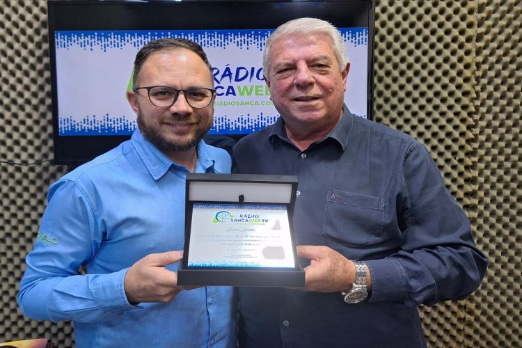 Paulo Gullo entrega placa de congratulações a jornalista